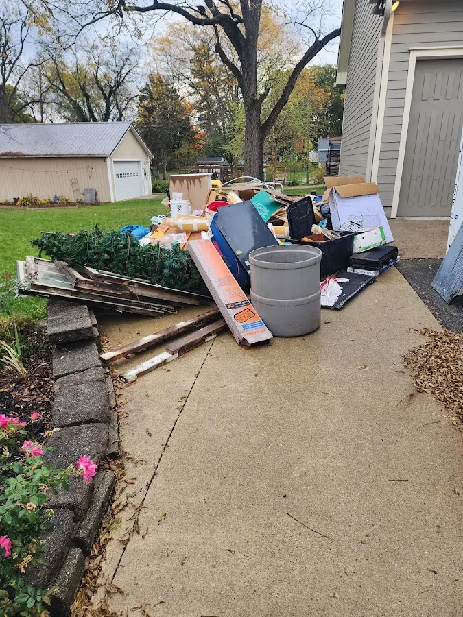 Dumpster being loaded with debris for Estate Cleanout Dumpster Rental in Wallace